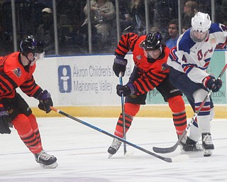 Phantoms' Liam Robertson, left, and Craig Needham and USA Hockey's National Team Development Program's Drew Helleson battle for the puck during their school day game on Wednesday. EMILY MATTHEWS | THE VINDICATOR