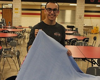 Neighbors | Abby Slanker.Canfield High School senior Dominic DeRamo partnered with Project MKC to complete his National Honor Society community service project and made no-sew blankets to be included in the organization’s comfort kits on Feb. 22..