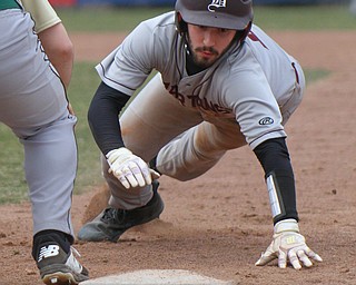 William D. Lewis The Vindicator BoardmanTravis Harvey(2) dives back to 1rst during a pick off attempt during 3-29-19 win over Ursuline at Cene.