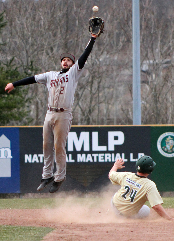 William D. Lewis The Vindicator Boardman's Travis Harvey(2) leaps for the ball as Ursuline's Andrew Sabella(24)steals 2nd during 3-29-19 game at Cene.