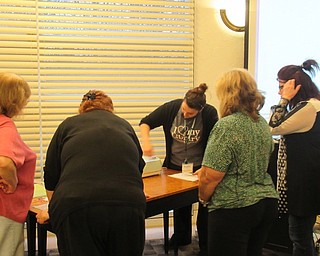 Neighbors | Jessica Harker.Librarian Renee Beverly instructed community members on how to open up and use the various tools with the cricut machine March 21 at the Austintown library.