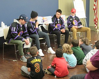 Neighbors | Jessica Harker.Four Phantoms hockey players read to children March 19 at the meet and greet event at the Boardman library.