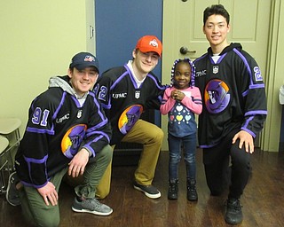 Neighbors | Jessica Harker.Phantoms hockey players, from right, Conner MacEachern, Liam Robertson and John Larkin posed with Arron Williams at the Phantoms meet and greet event March 19 at the Boardman library.