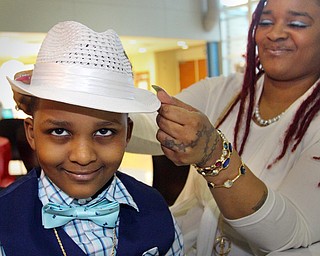 William D. Lewis The Vindicator  Comarie Fordham, 6, gets some help with his hat from his mom Mildred Howard during Mom and son event at East HS 3-29-19.