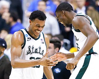 Michigan State forward Xavier Tillman, left, and teammate Gabe Brown, right, celebrate after the team's 80-63 win Friday night over LSU during an NCAA men's college basketball tournament East Region semifinal in Washington.