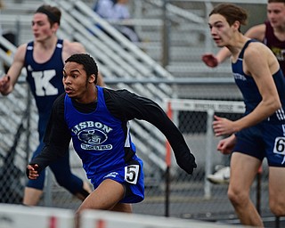 MINERAL RIDGE, OHIO - MARCH 30, 2019: Lisbon's Terrell Hunt runs ahead of Rootstown's Drake Duncan and Kennedy's Sam Marchione during a preliminary heat of the boys 110 yard hurdles, Saturday morning during the Joe Lane Invitational at Mineral Ridge High School. DAVID DERMER | THE VINDICATOR