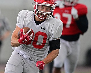 YOUNGSTOWN, OHIO - MARCH 30, 2019: Youngstown State's Joe Alessi runs away from James Jackson, red, during Saturday afternoon's spring scrimmage at the Watson and Tressel Training Facility. DAVID DERMER | THE VINDICATOR