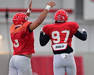 YOUNGSTOWN, OHIO - MARCH 30, 2019: Youngstown State's James Jackson, right, celebrates with Antoine Cook after a quarterback sack during Saturday afternoon's spring scrimmage at the Watson and Tressel Training Facility. DAVID DERMER | THE VINDICATOR