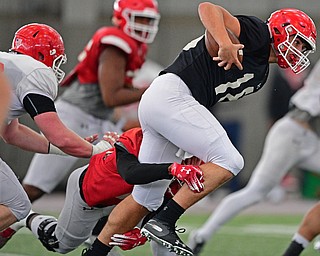 YOUNGSTOWN, OHIO - MARCH 30, 2019: Youngstown State's Mark Waid runs the ball while being tackled by Terray Bryant during Saturday afternoon's spring scrimmage at the Watson and Tressel Training Facility. DAVID DERMER | THE VINDICATOR