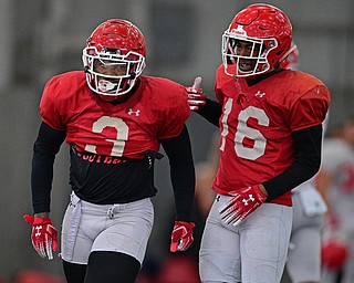 YOUNGSTOWN, OHIO - MARCH 30, 2019: Youngstown State's Cash Mitchell, left, is congratulated by Terray Bryant, right, after a tackle during Saturday afternoon's spring scrimmage at the Watson and Tressel Training Facility. DAVID DERMER | THE VINDICATOR