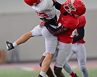 YOUNGSTOWN, OHIO - MARCH 30, 2019: Youngstown State's Michael Diaz, white, catches a pass against John Harper during Saturday afternoon's spring scrimmage at the Watson and Tressel Training Facility. DAVID DERMER | THE VINDICATOR