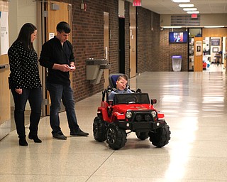 Meghan Houck (left) and Dan Houck (right) use a remote control to move their son Ryan Houck (5)  of Columbiana around the building during the Go Daddy Go event at the MCCTC in Canfield on Saturday morning.   Dustin Livesay  |  The Vindicator  3/30/19  MCCTC