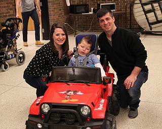 Meghan Houck (left) and Dan Houck (right) pose for a picture with their son Ryan Houck (5) all of Columbiana after Ryan took his new jeep for a drive around the building during the Go Daddy Go event at the MCCTC in Canfield on Saturday morning.   Dustin Livesay  |  The Vindicator  3/30/19  MCCTC