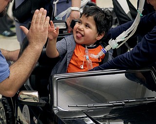 Mohammed Yasin (2) of Austintown gives high fives to everyone around after he sat in his new truck at the Go Daddy Go event at the MCCTC in Canfield on Saturday morning.   Dustin Livesay  |  The Vindicator  3/30/19  MCCTC\