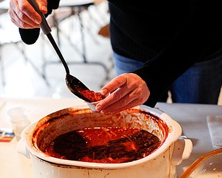 Mary McDonnell, of Canfield, scoops out chili at the eighth annual Chili Cookoff at Boardman United Methodist Church on Sunday. EMILY MATTHEWS | THE VINDICATOR