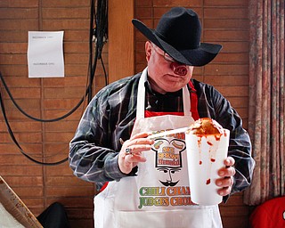 Dale Hawkins, of Boardman, fills a cup with his razorback chili, which won the Judges Choice first place award at the eighth annual Chili Cookoff at Boardman United Methodist Church on Sunday. EMILY MATTHEWS | THE VINDICATOR