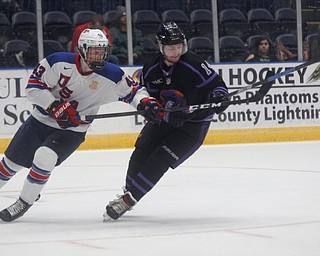 Phantoms' Dalton Messina and Team USA's Tyler Kleven go after the puck during their game on Sunday. EMILY MATTHEWS | THE VINDICATOR