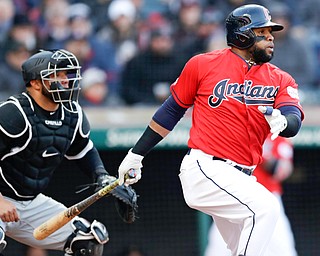 Cleveland Indians' Carlos Santana, right, watches his RBI-single off Chicago White Sox starting pitcher Ivan Nova in the sixth inning of Monday’s game in Cleveland. Jose Ramirez scored on the play. White Sox catcher Welington Castillo, left, also watches the hit.
