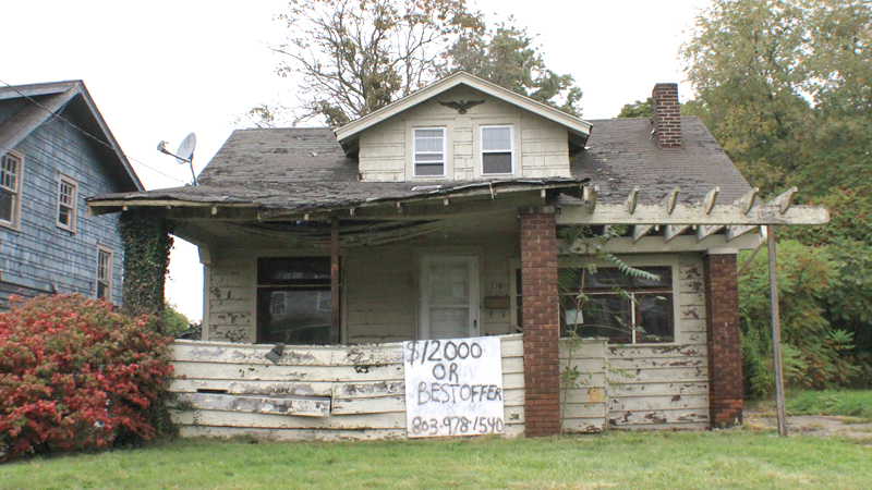 In this Vindicator file photo from last fall, a crudely drawn sign offering low-cost home ownership displays the phone number of Vision Property Management, a Columbia, S.C., real-estate management company that purchases and resells homes to individuals who wish to own a home but struggle to find financing. Community Legal Aid has sued Vision for alleged fraud and breach of contract. 