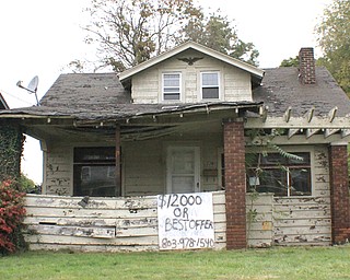 In this Vindicator file photo from last fall, a crudely drawn sign offering low-cost home ownership displays the phone number of Vision Property Management, a Columbia, S.C., real-estate management company that purchases and resells homes to individuals who wish to own a home but struggle to find financing. Community Legal Aid has sued Vision for alleged fraud and breach of contract. 