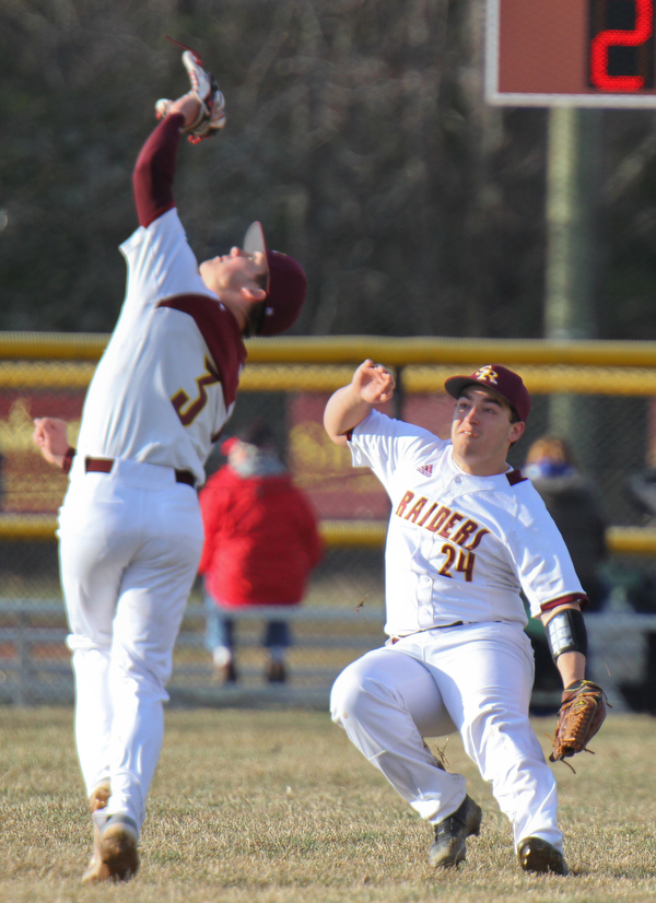 William D. Lewis the Vindicator  South Range's Trey Pancake(3) Ben Rivera(24) try to catch a flyball off th bat of Poland's Mason McCurdy during 4-2-19 game at South Range.