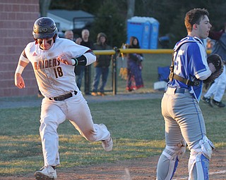 William D. Lewis the Vindicator  South Range's Jared Bajerski(18) heads for the plate as tying run in game with Poland.. Poland catcher MJ Farber(25) waits for the throw.