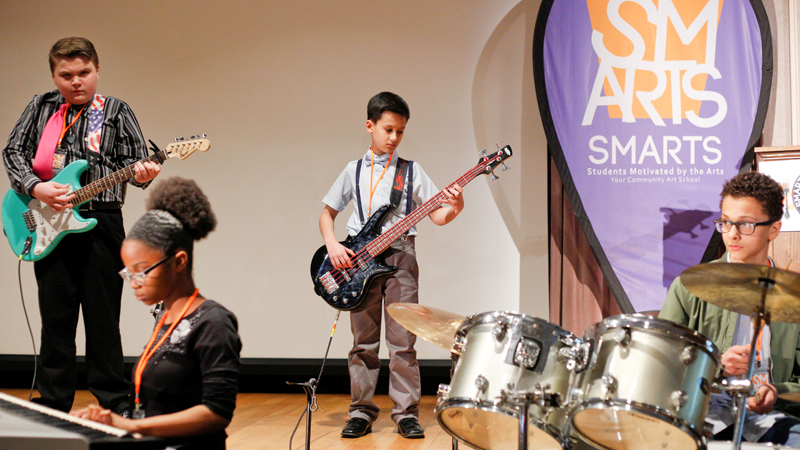 Members of the SMARTS Rock Band perform at the first SMARTS meeting and family dinner Wednesday at Stambaugh Auditorium in Youngstown. From left are Mike Gibson, 13, of Lowellville Middle School; Shanyla Smith, 13, of Austintown Middle School; Jimmy Pirone, 12, of Boardman Glenwood Junior High School; and Jorge Rodriguez, 13, of Austintown Middle.