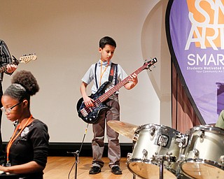 Members of the SMARTS Rock Band perform at the first SMARTS meeting and family dinner Wednesday at Stambaugh Auditorium in Youngstown. From left are Mike Gibson, 13, of Lowellville Middle School; Shanyla Smith, 13, of Austintown Middle School; Jimmy Pirone, 12, of Boardman Glenwood Junior High School; and Jorge Rodriguez, 13, of Austintown Middle.
