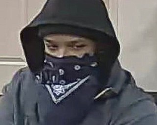 Home Savings is offering a $2,500 reward for information leading to the arrest or conviction of the man who held up their McCartney Road branch at gunpoint.