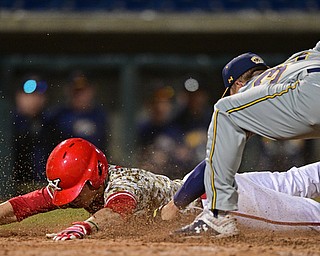 NILES, OHIO - APRIl 3, 2019: Youngstown State's Phillip Glasser slides into home plate beating the tag of Kent State relief pitcher Chris Martin in the eleventh inning of their game, Wednesday evening at Eastwood Field. Youngstown State won 4-3 in eleven innings. DAVID DERMER | THE VINDICATOR