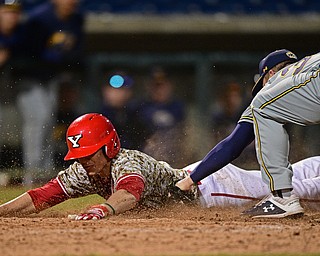 NILES, OHIO - APRIl 3, 2019: Youngstown State's Phillip Glasser slides into home plate beating the tag of Kent State relief pitcher Chris Martin in the eleventh inning of their game, Wednesday evening at Eastwood Field. Youngstown State won 4-3 in eleven innings. DAVID DERMER | THE VINDICATOR