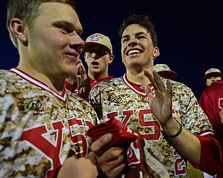 NILES, OHIO - APRIl 3, 2019: Youngstown State's Phillip Glasser, right, smiles while being mobbed by his teammates after scoring the winning run in the eleventh inning of their game, Wednesday evening at Eastwood Field. Youngstown State won 4-3 in eleven innings. DAVID DERMER | THE VINDICATOR