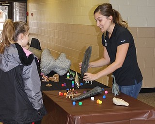 Neighbors | Abby Slanker.Leslie Wilson, Carnegie Museum of Natural History outreach manager. talked about dinosaur fossils with Hilltop Elementary School students at the school’s annual book fair K.I.S.S. event on March 7.
