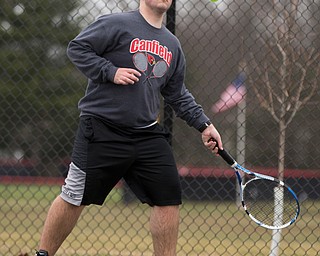 Canfield senior Reilly Todd hits the ball during a doubles match against Howland at Canfield High School on Thursday. EMILY MATTHEWS | THE VINDICATOR