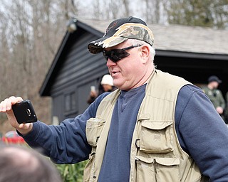 Bill Miller, of Niles, watches as rainbow trout are released into Lake Glacier on Thursday. EMILY MATTHEWS | THE VINDICATOR