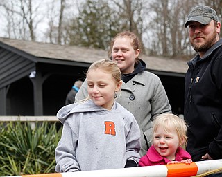 Ayvah Sheely, 7, left, and Scarlet Sheely, 2, watch with their parents Misty and Wayne Sheely as rainbow trout are released into Lake Glacier on Thursday. EMILY MATTHEWS | THE VINDICATOR
