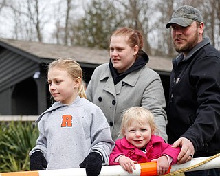 Ayvah Sheely, 7, left, and Scarlet Sheely, 2, watch with their parents Misty and Wayne Sheely as rainbow trout are released into Lake Glacier on Thursday. EMILY MATTHEWS | THE VINDICATOR