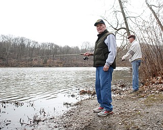 Brothers Jerry, left, and Karl Roach, both of Boardman, fish for rainbow trout after they were released into Lake Glacier on Thursday. EMILY MATTHEWS | THE VINDICATOR