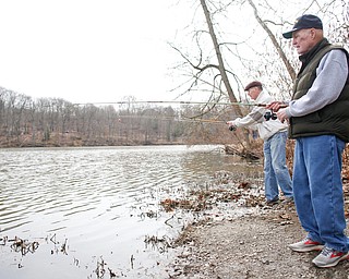 Brothers Jerry, right, and Karl Roach, both of Boardman, fish for rainbow trout after they were released into Lake Glacier on Thursday. EMILY MATTHEWS | THE VINDICATOR