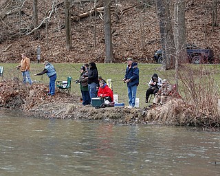 People fish for rainbow trout after they were released into Lake Glacier on Thursday. EMILY MATTHEWS | THE VINDICATOR