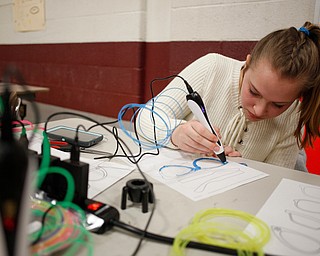 Savanna Watkins, 12, a seventh grader at Glenwood Junior High School, uses 3-D pen to make glasses during STEAM night at Glenwood Junior High School on Friday night. EMILY MATTHEWS | THE VINDICATOR