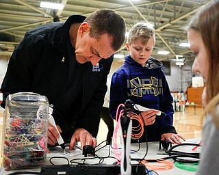 Father and son Ken and Ryan, 10, Timmings, of Boardman, use 3-D pens during STEAM night at Glenwood Junior High School on Friday night. EMILY MATTHEWS | THE VINDICATOR