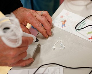 Ken Timmings, of Boardman, uses a 3-D pen to make a heart during STEAM night at Glenwood Junior High School on Friday night. Ken was there with his 10-year-old son Ryan. EMILY MATTHEWS | THE VINDICATOR