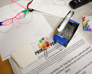 Glasses and a bookmark made by eighth grade art teacher Chelsea Wishbar using a 3-D pen are displayed during STEAM night at Glenwood Junior High School on Friday night. EMILY MATTHEWS | THE VINDICATOR