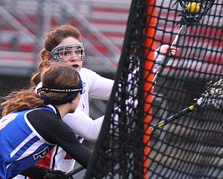 William D. Lewis The vindicator  Canfield's Isabella Kelty 22 shoots past Poland's Catherine Sicafuse(9)during 4-5-19 game with Poland.