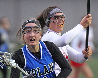 William D. Lewis The vindicatorPoland's Addison Kaschak(1) and Canfield's Athena Poullas(37) go for the ball during 4-5-19 game.