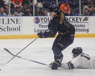 Phantoms' Craig Needham keeps possession of the puck as Stampede's Anthony Romano falls during the second period of their game Saturday night. EMILY MATTHEWS | THE VINDICATOR