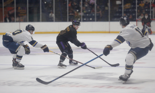 Phantoms' Ben Schoen tries to keep the puck from Stampede's Sam Stevens, left, and Ryan Sullivan during the second period of their game Saturday night. EMILY MATTHEWS | THE VINDICATOR