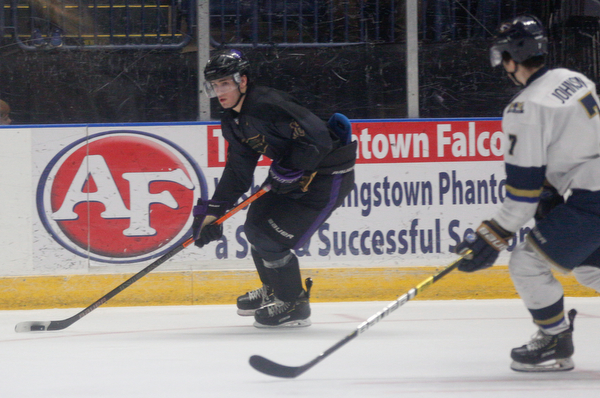 Phantoms' Jack Malone looks towards the goal as Stampede's Ryan Johnson comes up behind him during the second period of their game Saturday night. EMILY MATTHEWS | THE VINDICATOR