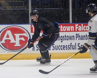 Phantoms' Jack Malone looks towards the goal as Stampede's Ryan Johnson comes up behind him during the second period of their game Saturday night. EMILY MATTHEWS | THE VINDICATOR